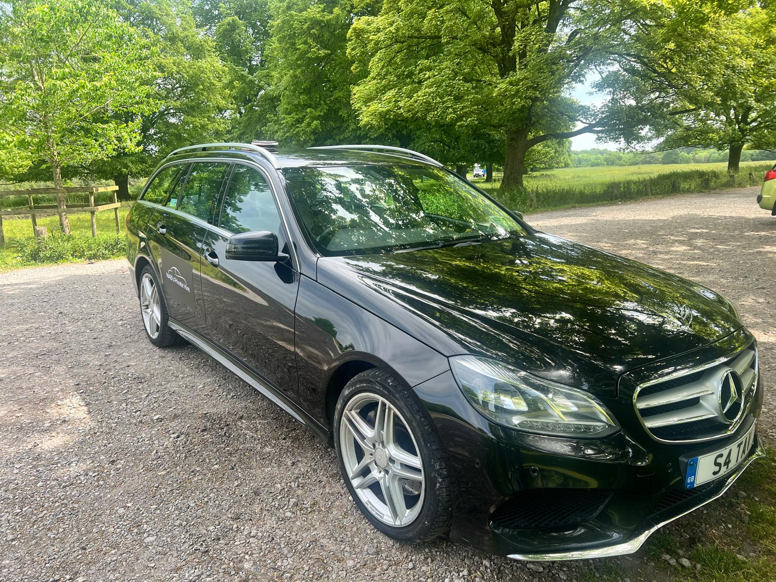 NABs Private Hire black Mercedes-Benz E-Class E350 waiting on the airport forecourt